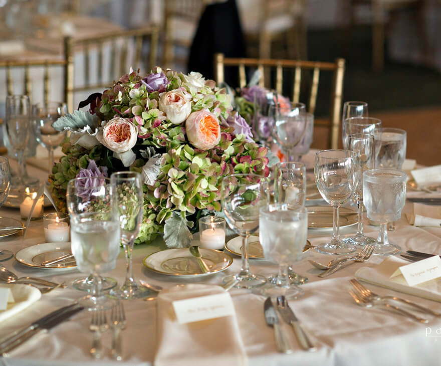 table set for an event with flower centerpiece